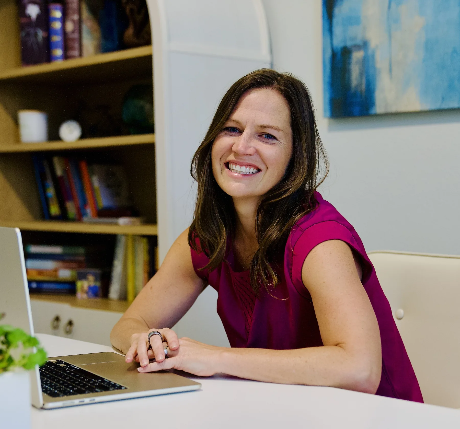 Wendy Copeland smiling at a laptop in her office